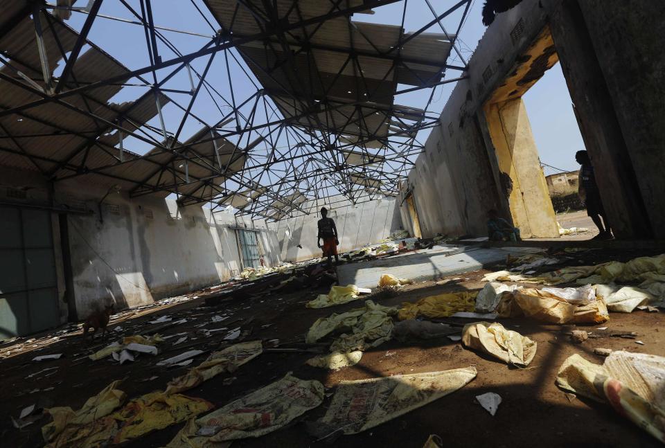 A fisherman walks inside a damaged port building after Cyclone Phailin hit Gopalpur village