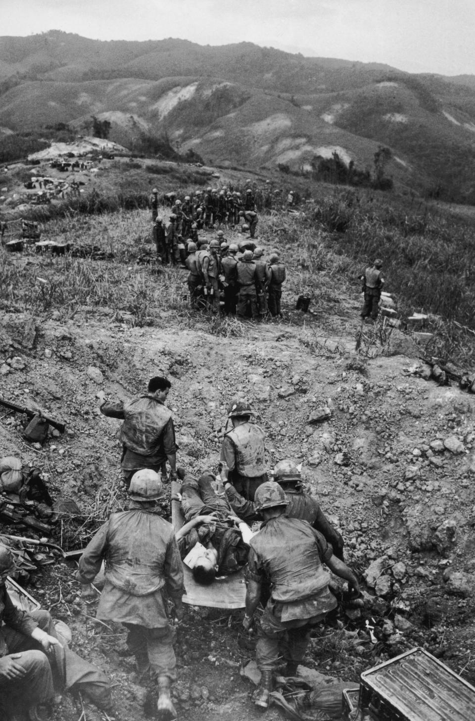 <p>A stretcher party carries a wounded American soldier down Hill Timothy during the Vietnam War, 25th October 1968. (Photo: Terry Fincher/Daily Express/Hulton Archive/Getty Images) </p>