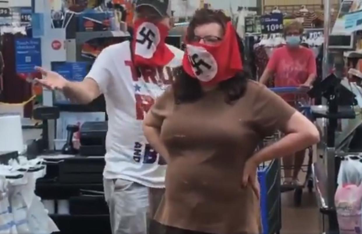 A couple wearing swastika masks inside a Walmart in Marshall, Minnesota: Twitter