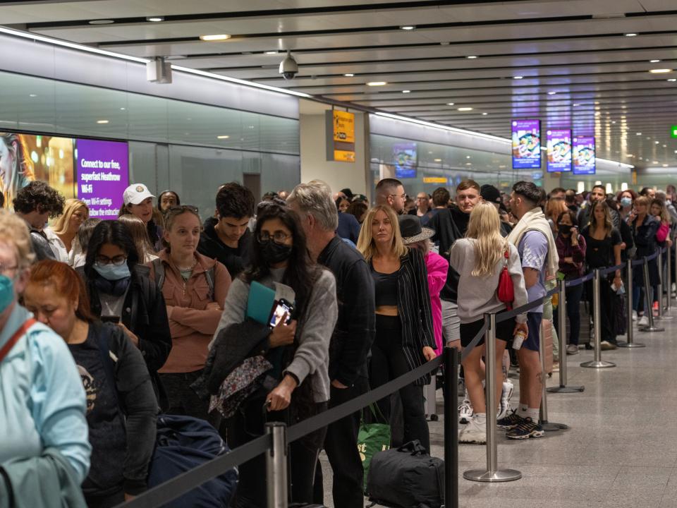 People wait in long queues for security at Heathrow Airport on June 1.