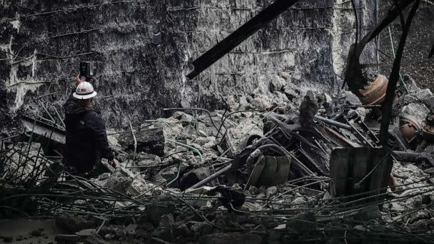 PHOTO: An investigator surveys the aftermath of an elevated section of Interstate 95 that collapsed, in Philadelphia, June 12, 2023. (Matt Rourke/AP)