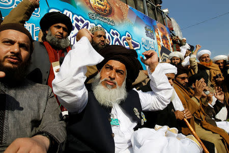 Khadim Hussain Rizvi (C), leader of Tehrik-e-Labaik Pakistan islamist political party, raises his arms as supporters chant slogans at their protest site at Faizabad junction in Islamabad, Pakistan November 27, 2017. REUTERS/Caren Firouz