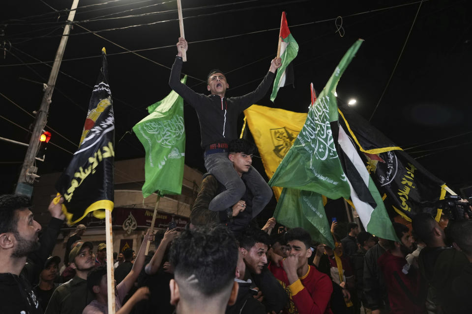 Palestinians celebrate the announcement of a cease-fire after five days of fighting between Israel and the Islamic Jihad militant group in Gaza City, Saturday, May 13, 2023. The two sides agreed to an Egyptian-brokered truce late Saturday, halting fighting that 33 Palestinians, including at least 13 civilians, dead. Two people in Israel were killed by rocket fire. (AP Photo/Adel Hana)