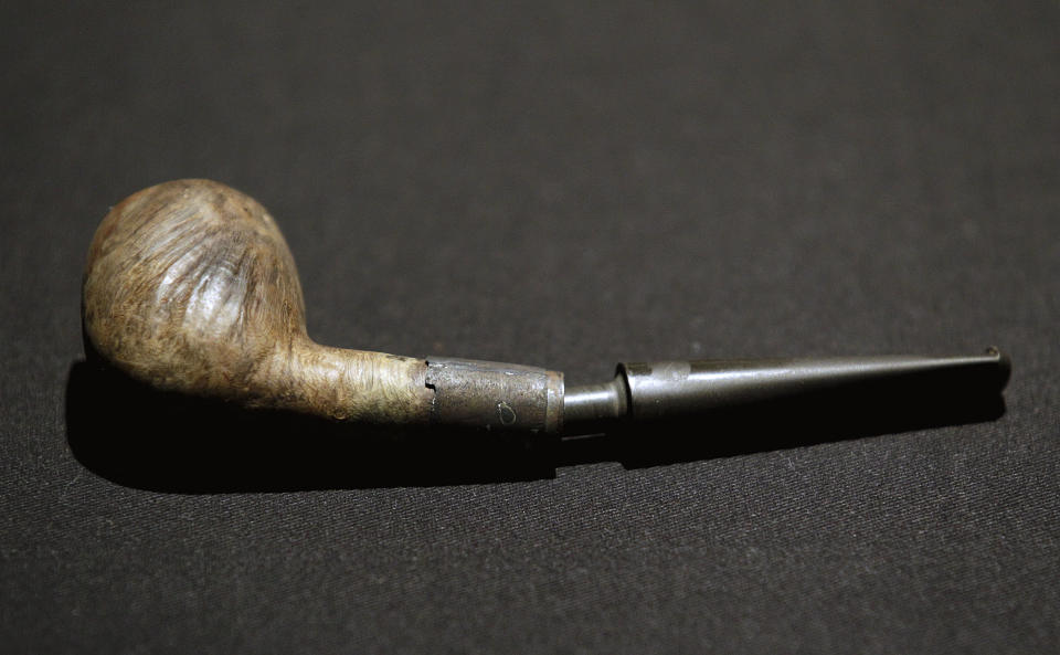 A pipe belonging to William Murdoch, the bridge officer aboard the Titanic, is seen on display before an exhibition opens to the public Tuesday, April 3, 2012, in Atlanta. From the pitch-black depths 2½ miles beneath the North Atlantic, salvagers of the Titanic made a notable discovery when they located the personal effects of Murdoch, the bridge officer who tried in vain to keep the doomed ship from colliding with an iceberg. The artifacts, including a shoe brush, straight razor and pipe, are the first to be specifically to Murdoch, a central figure in the disaster who gained added notoriety after James Cameron’s polemical portrayal of him in the 1997 blockbuster movie “Titanic.” (AP Photo/David Goldman)