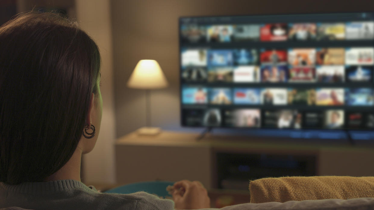  Girl binge-watching a streaming platform. 