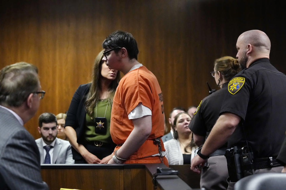 Ethan Crumbly is escorted by sheriff deputies after being sentenced, Friday, Dec. 8, 2023, in Pontiac, Mich. Crumbly sentenced to life in prison for killing four students, wounding more and terrorizing Michigan's Oxford High School in 2021. A judge Friday rejected pleas for a shorter sentence and ensured that Crumbley, 17, will not get an opportunity for parole. (AP Photo/Carlos Osorio)