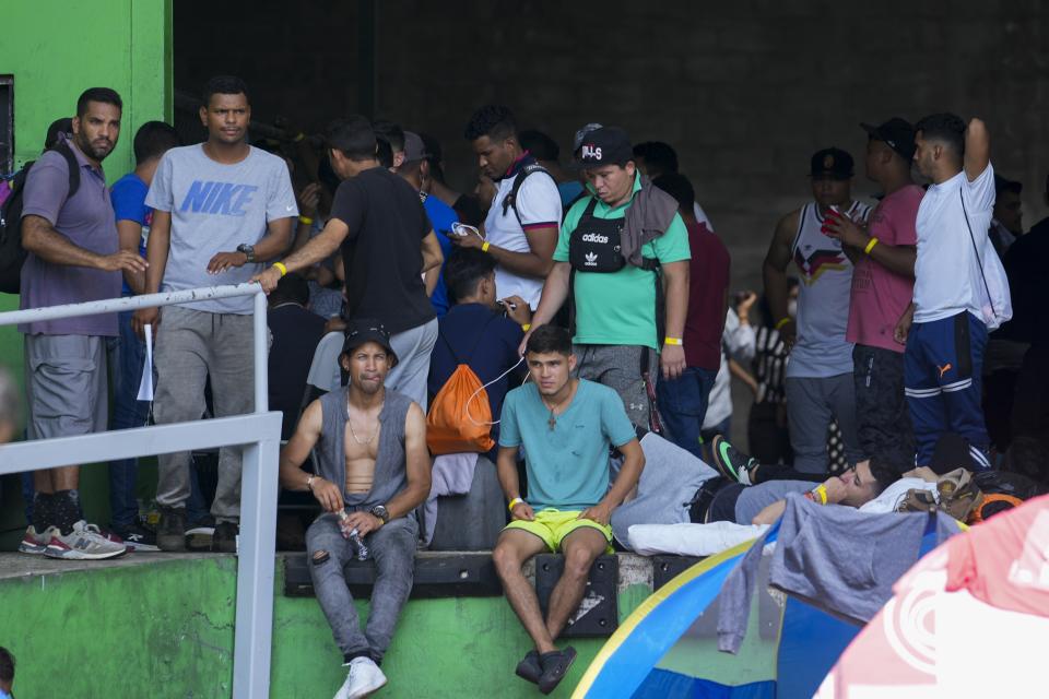 Venezuelan migrants hoping to return to their country of origin, wait at a commercial warehouse being used as a temporary shelter, in Panama City, Wednesday, Oct. 26, 2022. (AP Photo/Arnulfo Franco)