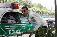 <p>An Iranian policeman takes cover during an attack on the Iranian parliament in central Tehran, Iran, June 7, 2017. (Photo: Tasnim News Agency/Handout via Reuters) </p>