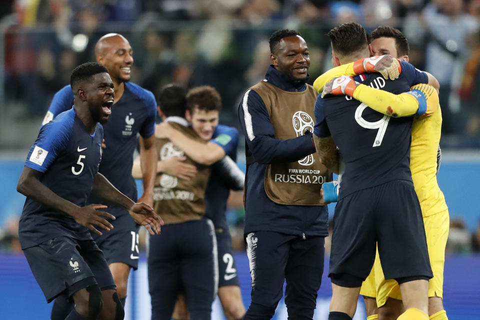 <p>France’s Samuel Umtiti, left, celebrates with team mates after the semifinal match between France and Belgium at the 2018 soccer World Cup in the St. Petersburg Stadium in, St. Petersburg, Russia, Tuesday, July 10, 2018. (AP Photo/Frank Augstein) </p>