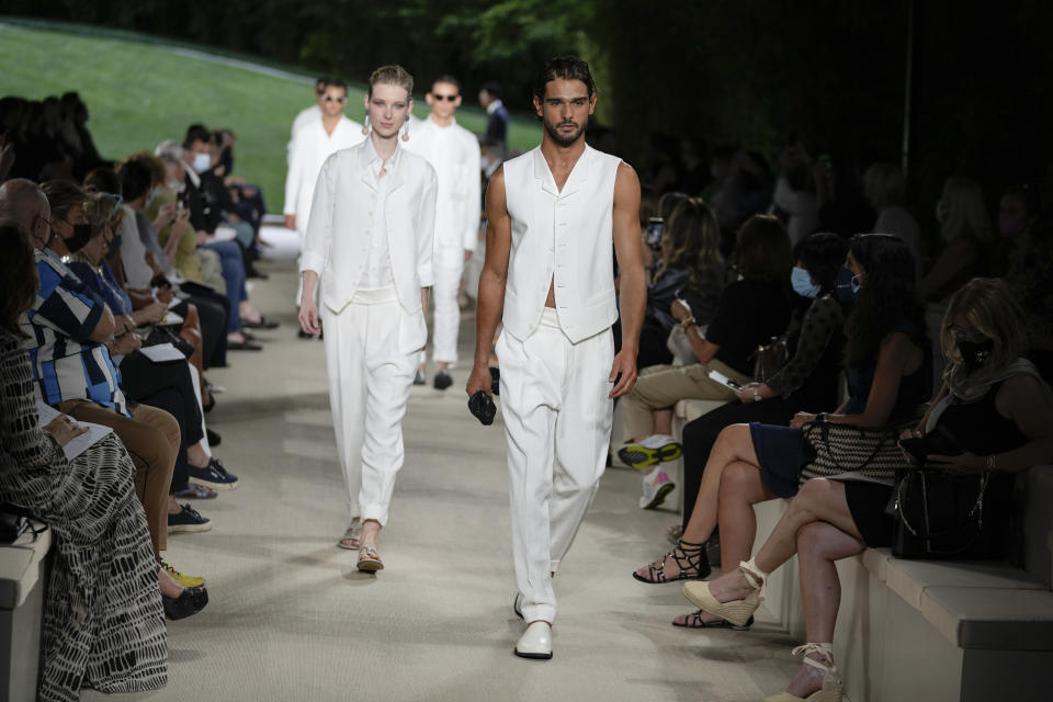 Models wear creations as part of the Giorgio Armani men's Spring Summer 2022 collection, in Milan, Italy, Monday, June 21, 2021. (AP Photo/Luca Bruno)