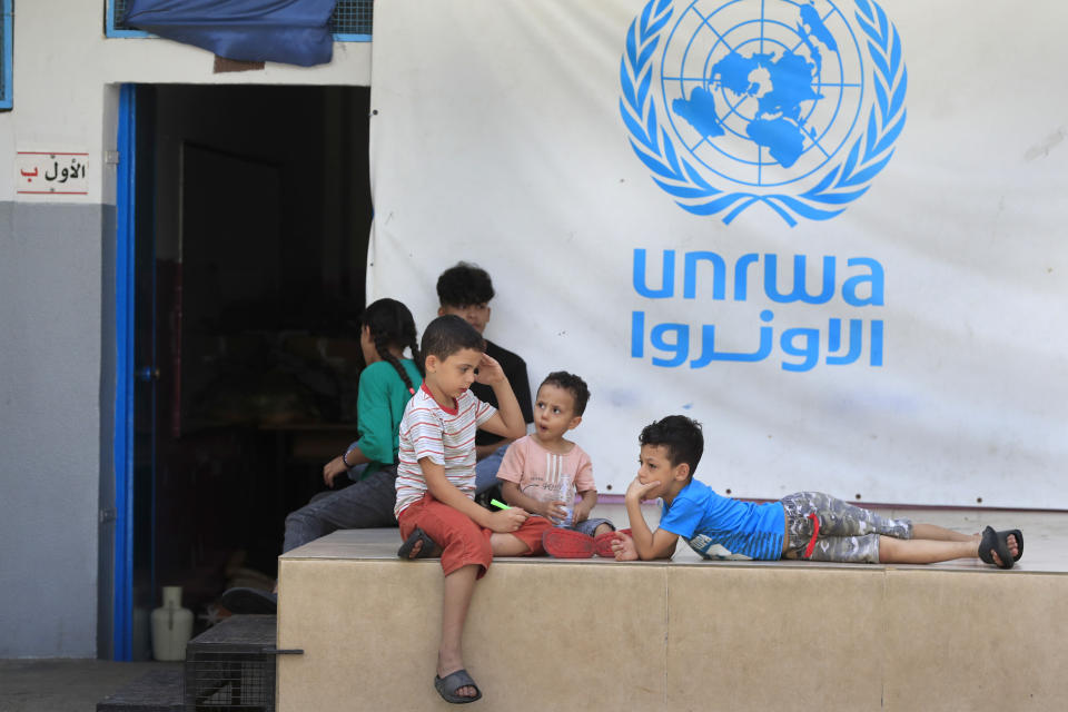 FILE - Palestinian children who fled with their parents from their houses in the Palestinian refugee camp of Ein el-Hilweh, gather in the backyard of an UNRWA school, in Sidon, Lebanon, Sept. 12, 2023. An independent review released Monday, April 22, 2024, of the neutrality of UNRWA, the U.N. agency helping Palestinian refugees, has found that Israel never expressed concern about anyone on the staff lists it has received annually since 2011. The review was carried out after Israel alleged that a dozen employees of the agency had participated in Hamas’ Oct. 7 attacks. (AP Photo/Mohammed Zaatari, File)