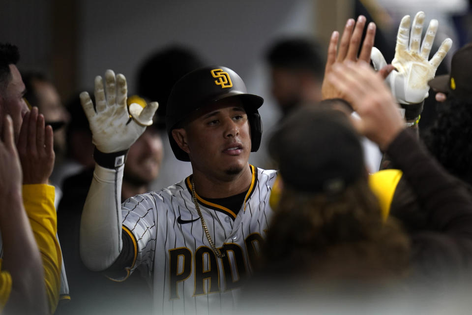 San Diego Padres' Manny Machado celebrates with teammates after hitting a home run during the fourth inning of a baseball game against the San Francisco Giants, Thursday, July 7, 2022, in San Diego. (AP Photo/Gregory Bull)