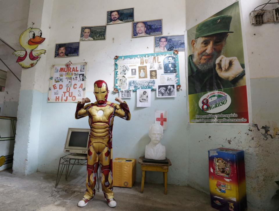 Third grade student at the Enrique Villuendas Primary School, Christian Jesus, poses in his Iron Man costume in Havana