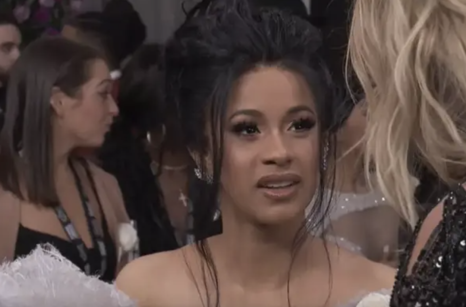 Cardi B looking shocked while being interviewed on a red carpet