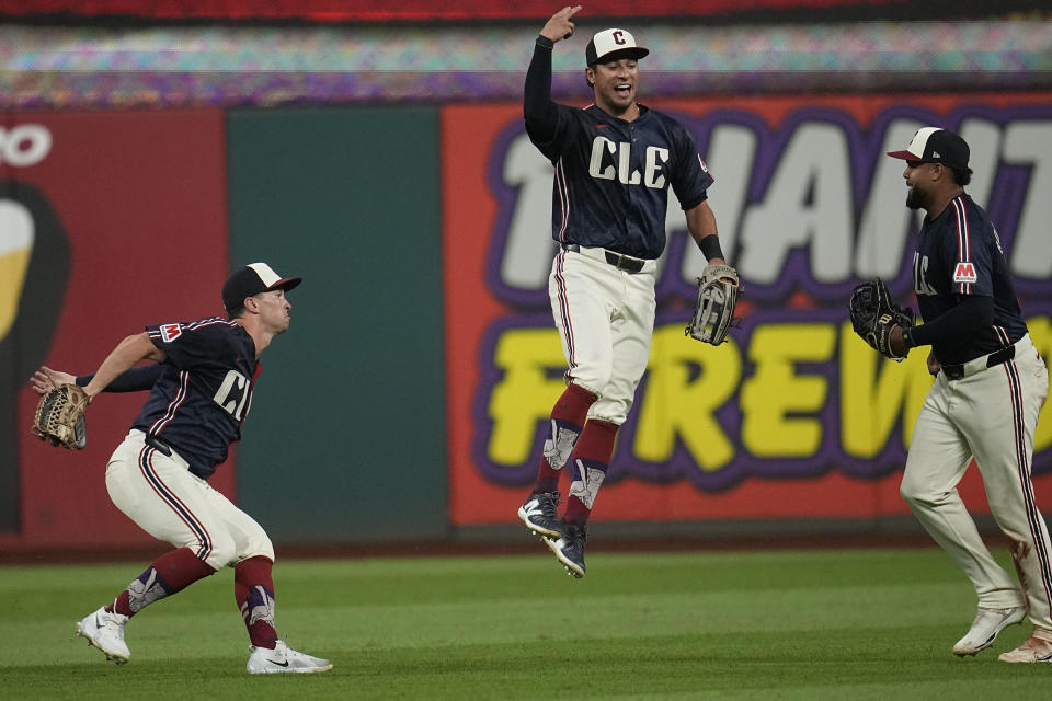 Cleveland Guardians outfielders, from left, Will Brennan, Tyler Freeman and Johnathan Rodriguez celebrate after the Guardians defeated the Toronto Blue Jays in a baseball game Friday, June 21, 2024, in Cleveland. (AP Photo/Sue Ogrocki)