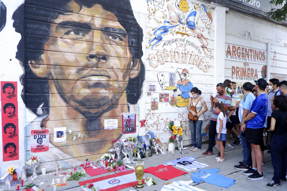 Fans mourn Diego Maradona in an altar outside Argentinos Juniors' Diego Maradona Stadium in Buenos Aires, Argentina. Diego Maradona, considered one of the biggest football stars in history, died at 60 from a heart attack on Wednesday in Buenos Aires. 