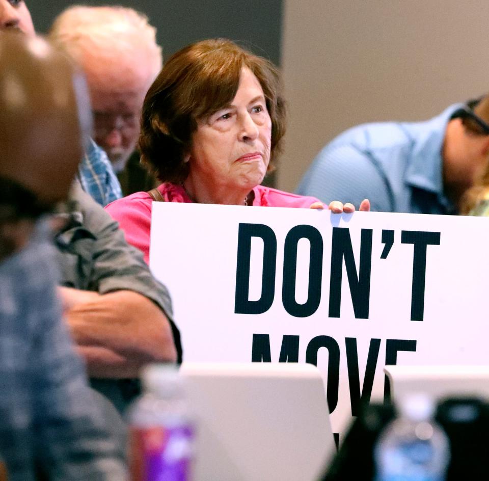 Reba Hinkle holds up a sign to save Cannonsburgh Village during a meeting of the Murfreesboro City Council on Thursday, Sept. 14, 2023, where a new minor league AA baseball stadium and team coming to Murfreesboro was discussed.