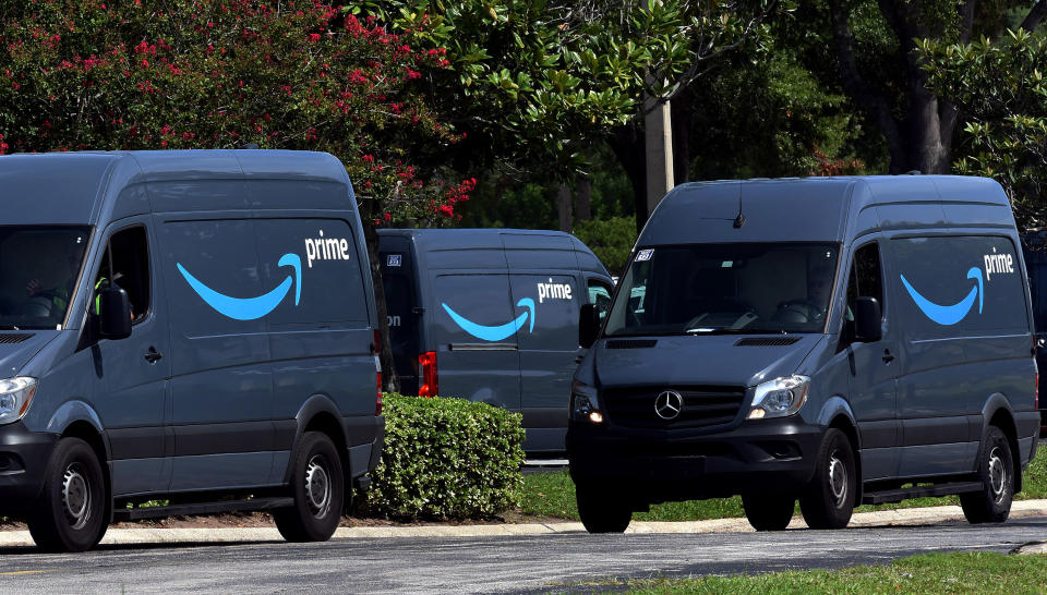 Amazon vans head to a distribution center to pick up packages for delivery on Amazon Prime Day, July 16, 2019, in Orlando, Florida.  (Photo by Paul Hennessy/NurPhoto via Getty Images)