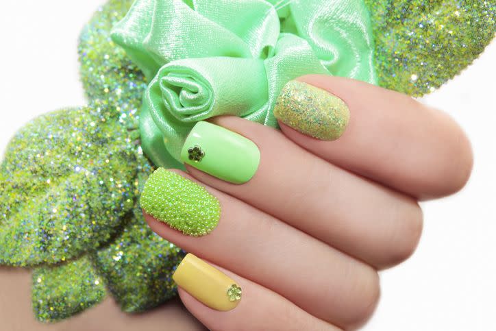 manicure with green rose and a different design of sequins and rhinestones on nails