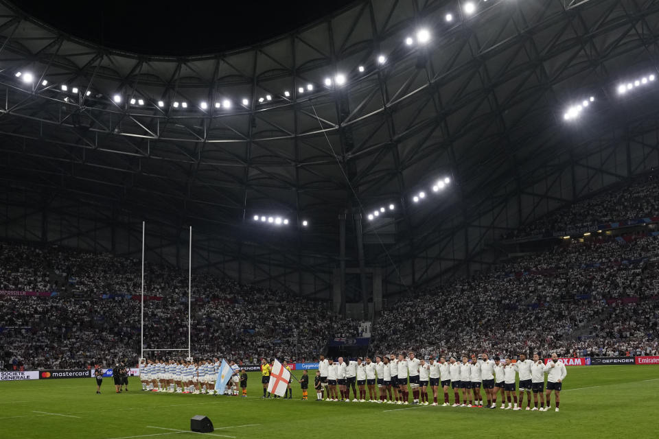 The two teams line up for the national anthem just prior to kick off, England are right, at the Rugby World Cup Pool D match between England and Argentina in the Stade de Marseille, Marseille, France Saturday, Sept. 9, 2023. (AP Photo/Pavel Golovkin)