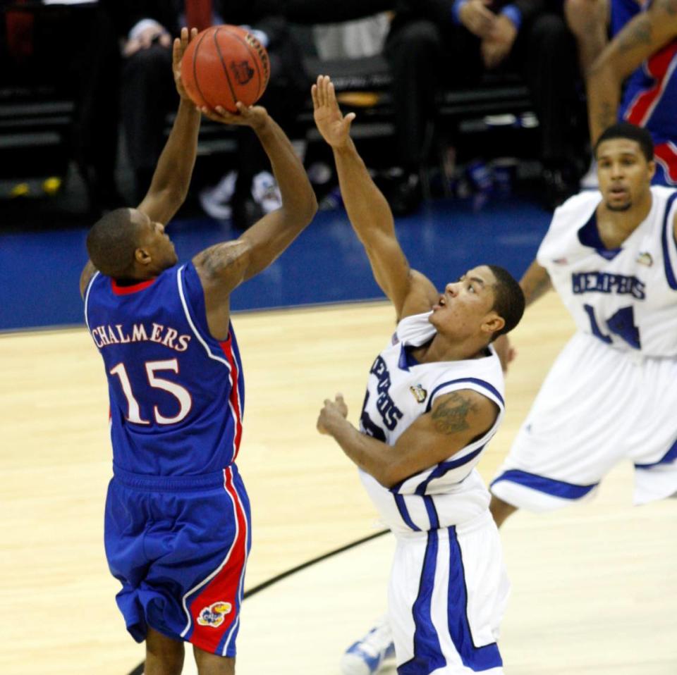 Kansas Jayhawks guard Mario Chalmers (15) takes a 3-point shot over Memphis Tigers guard Derrick Rose (23) with less than 5 seconds remaining in the 2008 NCAA National Championship game at the Alamodome on April 7, 2008.