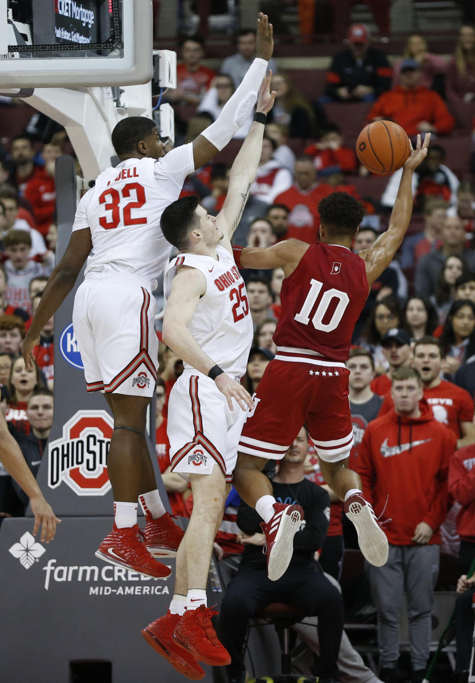 Indiana's Rob Phinisee, right, tries to shoot over Ohio State's E.J. Liddell, left, and Kyle Young during the second half of an NCAA college basketball game Saturday, Feb. 1, 2020, in Columbus, Ohio. Ohio State beat Indiana 68-59. (AP Photo/Jay LaPrete)