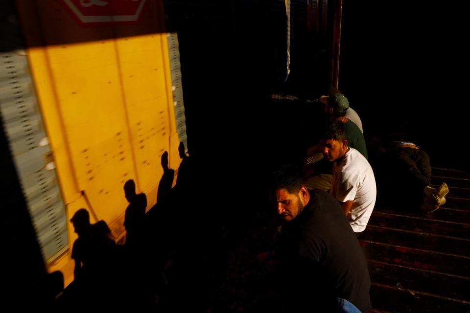 Migrants travel on a train, with the intention of reaching the United States, on the outskirts of Ciudad Juarez (Reuters)