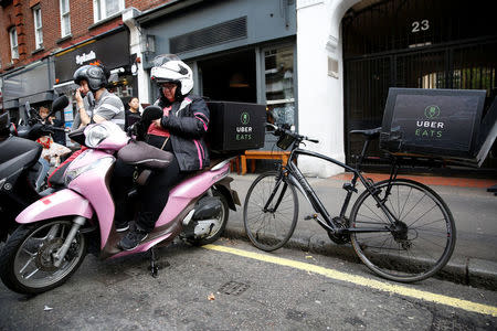 An UberEATS food delivery courier waits for an order in London, Britain September 7, 2016. REUTERS/Neil Hall