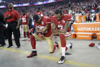 FILE - In this Sept. 12, 2016, file photo, San Francisco 49ers safety Eric Reid (35) and quarterback Colin Kaepernick (7) kneel during the national anthem before an NFL football game against the Los Angeles Rams in Santa Clara, Calif. When Colin Kaepernick took a knee during the national anthem to take a stand against police brutality, racial injustice and social inequality, he was vilified by people who considered it an offense against the country, the flag and the military. (AP Photo/Marcio Jose Sanchez, File)