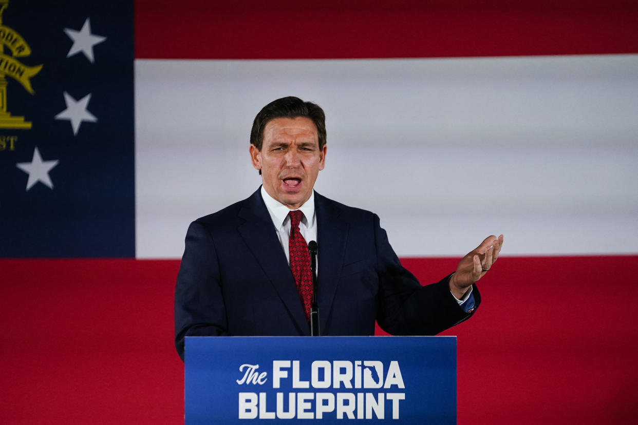 Gov. Ron DeSantis at the microphone, at a podium saying: The Florida Blueprint.