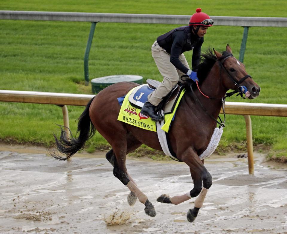 Exercise rider Kelvin Pahal takes Kentucky Derby hopeful Wicked Strong for a morning workout at Churchill Downs Monday, April 28, 2014, in Louisville, Ky. (AP Photo/Charlie Riedel)