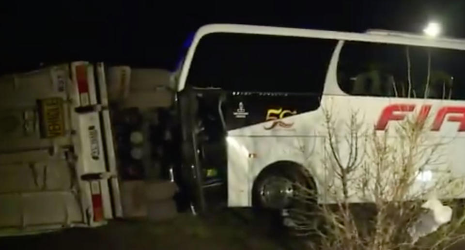 A bus is seen smashed against a B-double trailer at the Western Highway near Pimpinio. The bus driver died.