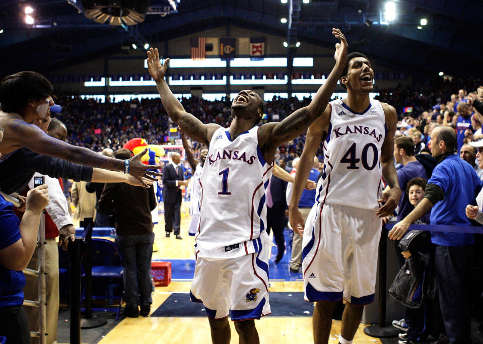 LAWRENCE, KS - DECEMBER 10: Naadir Tharpe #1 and Kevin Young #40 of the Kansas Jayhawks celebrate as they leave the court after the Jayhawks defeated the Ohio State Buckeyes 78-67 to win the game on December 10, 2011 at Allen Fieldhouse in Lawrence, Kansas. (Photo by Jamie Squire/Getty Images)