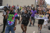 Deandre Jones leads chants through a megaphone during a march through downtown Grand Rapids, Mich., on Saturday, April 23, 2022. The march, which was organized by the Breonna Taylor Foundation, began at Veterans Park in response to the shooting death of Patrick Lyoya by a Grand Rapids police officer on April 4. (Daniel Shular/The Grand Rapids Press via AP)