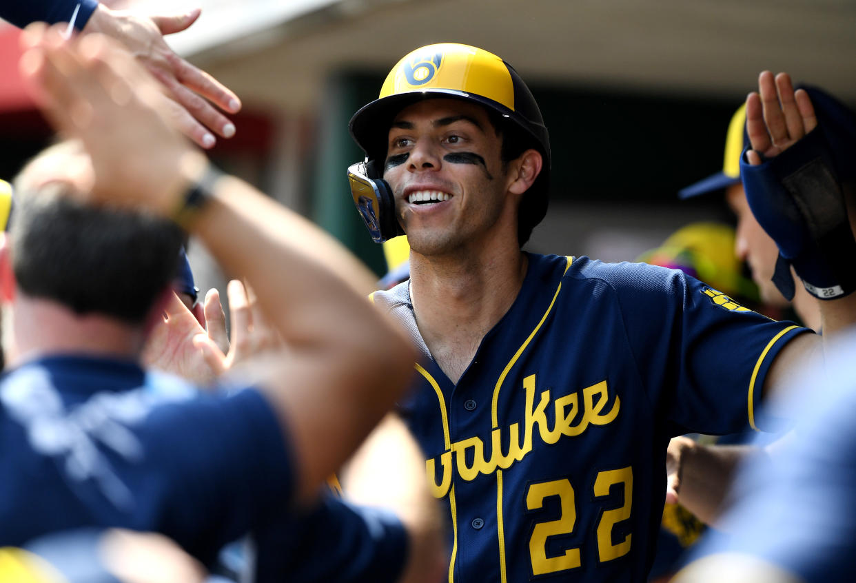 CINCINNATI, OHIO - MAY 11: Christian Yelich #22 of the Milwaukee Brewers celebrates in the dugout after hitting a triple for a cycle in the ninth inning during a game against the Cincinnati Reds at Great American Ball Park on May 11, 2022 in Cincinnati, Ohio. (Photo by Emilee Chinn/Getty Images)