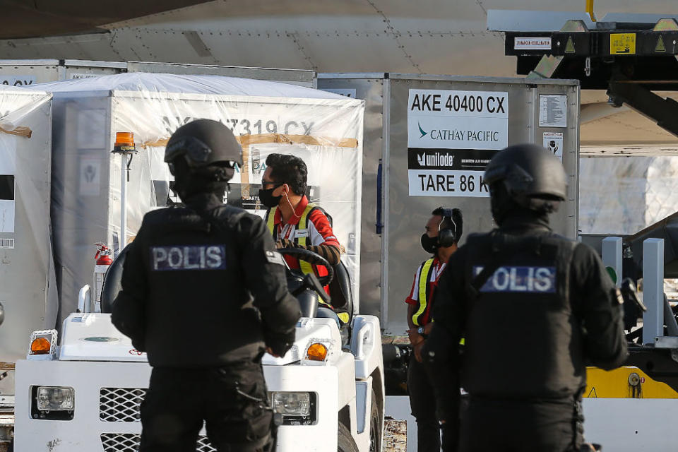 The first batch of Pfizer-BioNTech Covid-19 vaccine is moved into DHL transport van after arriving at Malaysia Airline Berhad (MAS) Penang Cargo Complex, Bayan Lepas on February 21, 2021. — Picture by Sayuti Zainudin