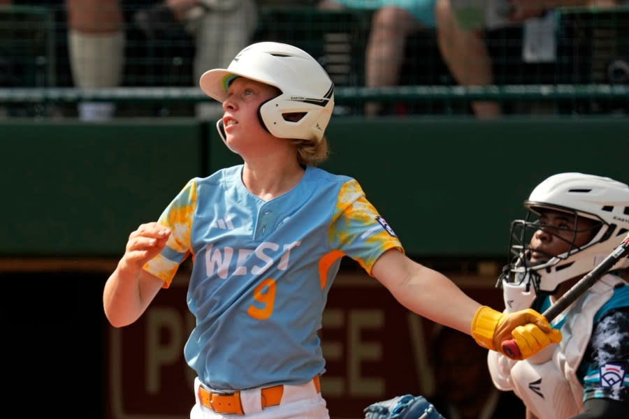 El Segundo, Calif.’s Lucas Keldorf (9) follows through on a double off Curacao’s Sean Serverie, driving in two runs, during the first inning of the Little League World Series Championship game in South Williamsport, Pa., Sunday, Aug. 27, 2023. (AP Photo/Gene J. Puskar)