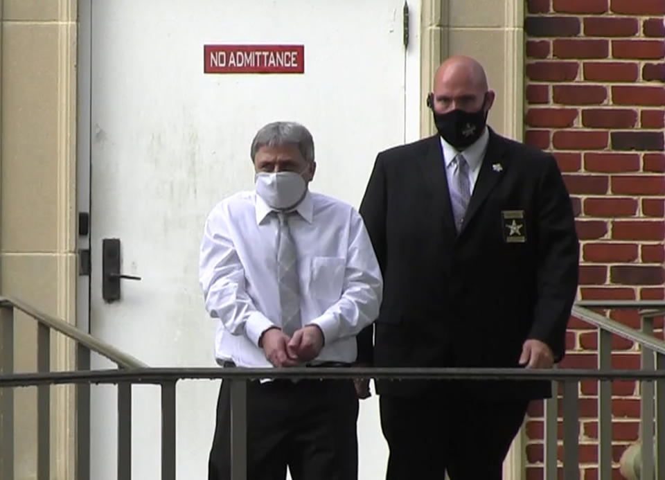 In this image from video, Roddy Bryant, accused in the slaying of Ahmaud Arbery, is led by security officers from the Glynn County Courthouse in Brunswick, Ga., Wednesday, May 12, 2021. A Georgia judge will continue hearing legal motions Thursday in the murder case of three men facing a fall trial in the slaying of Arbery, a Black man who was chased and shot after being spotted running in the defendants' neighborhood. (AP Photo/Lewis M. Levine)