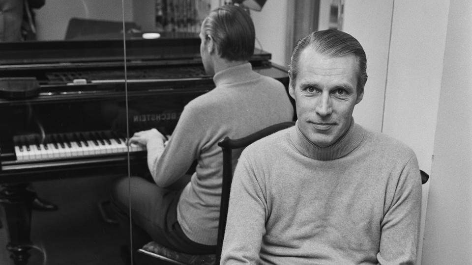 George Martin sitting at the piano
