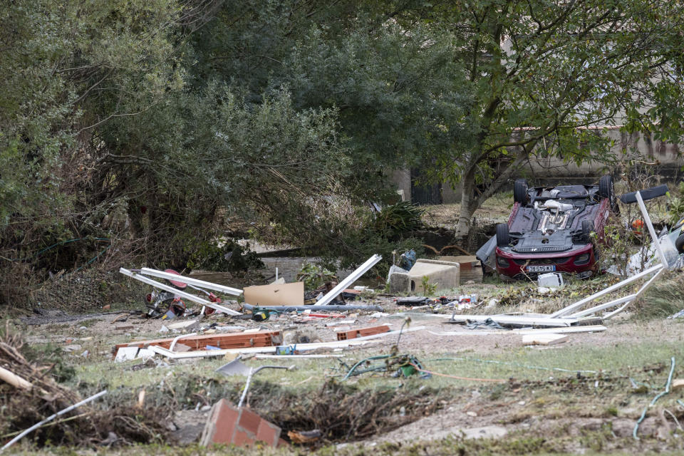 A car and debris are pictured after floods in the town of Villegailhenc, southern France, Monday, Oct.15, 2018. Flash floods tore through towns in southwest France, turning streams into raging torrents that authorities said killed several people and seriously injured at least five others. (AP Photo/Fred Lancelot)