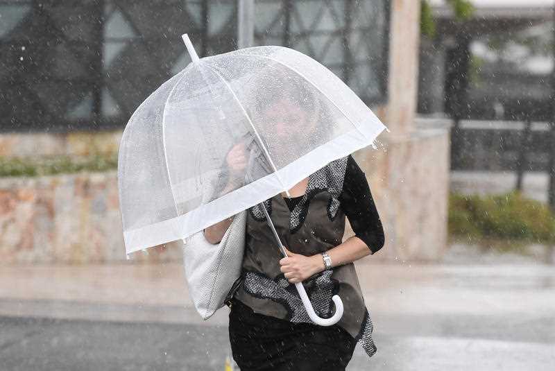 A woman walks in rainy weather in central Brisbane.