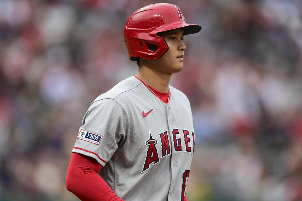 Los Angeles Angels' Shohei Ohtani walks to first base during the fifth inning of the team's baseball game against the Cleveland Guardians, Saturday, May 13, 2023, in Cleveland. (AP Photo/David Dermer)