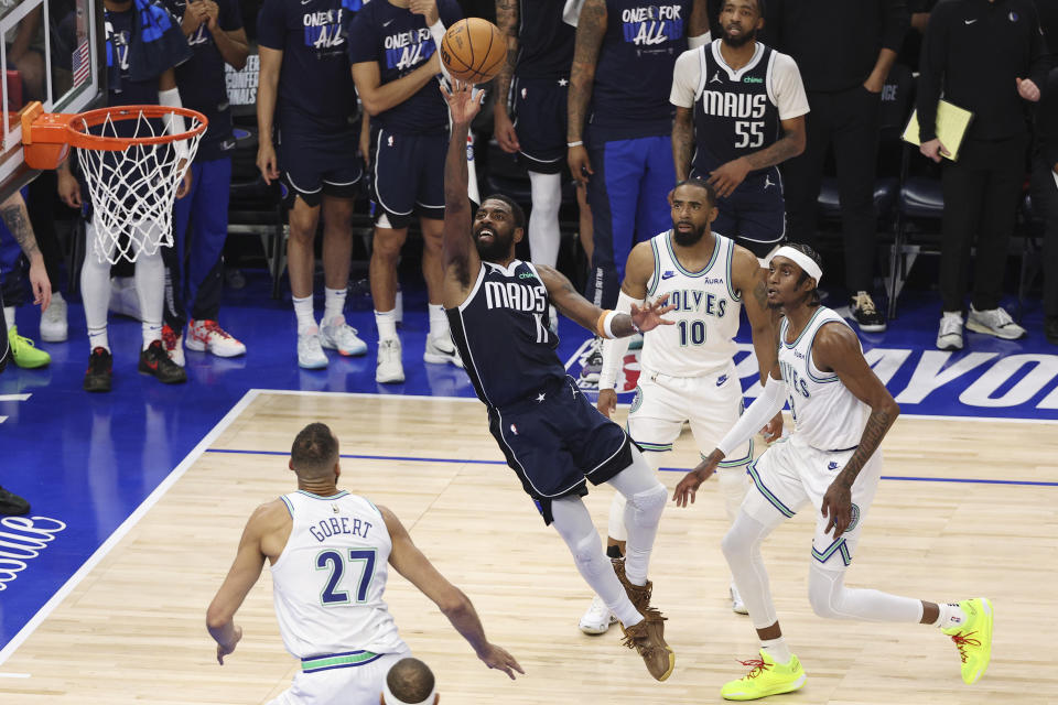 Dallas Mavericks guard Kyrie Irving (11) drives to the basket against the Minnesota Timberwolves during Game 1 of the NBA basketball Western Conference finals, Wednesday, May 22, 2024, in Minneapolis. (AP Photo/Matt Krohn)