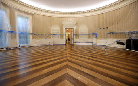 The Oval Office sits empty and the walls covered with plastic sheeting during renovation work at the White House August 11, 2017 in Washington, DC - Credit: Getty