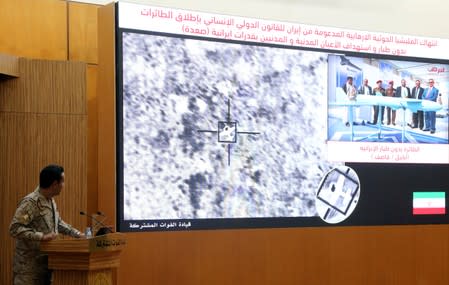 Official spokesperson for the Saudi-led coalition fighting in Yemen, Colonel Turki Al-Malik, displays on a screen a satellite image shows an drone strike during a news conference, in Riyadh