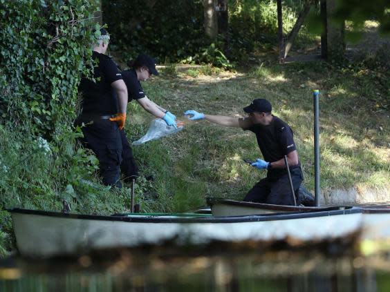 Police forensic officers gather evidence near the boats by the lake on the grounds of Lullingstone Castle in Eynsford, Kent (PA)
