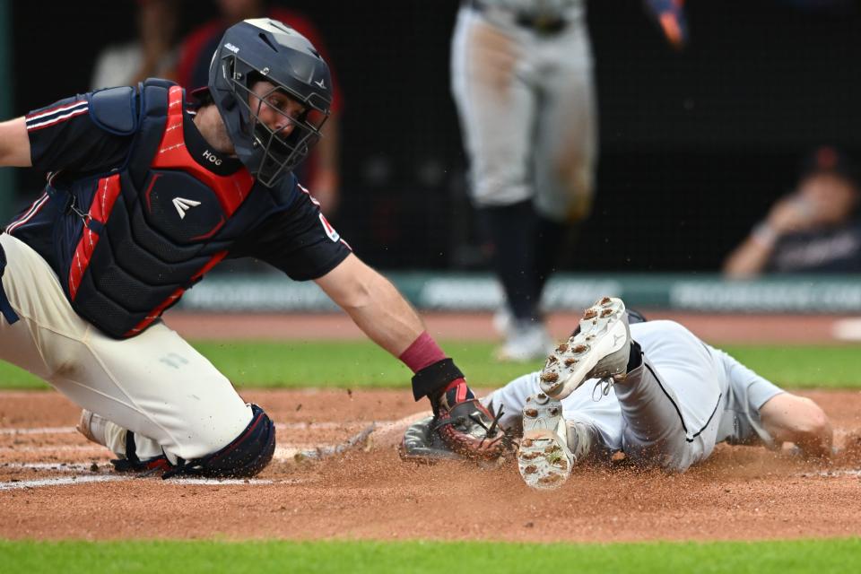 igers catcher Jake Rogers scores past the tag of Guardians catcher Austin Hedges during the second inning, July 22, 2024, in Cleveland.