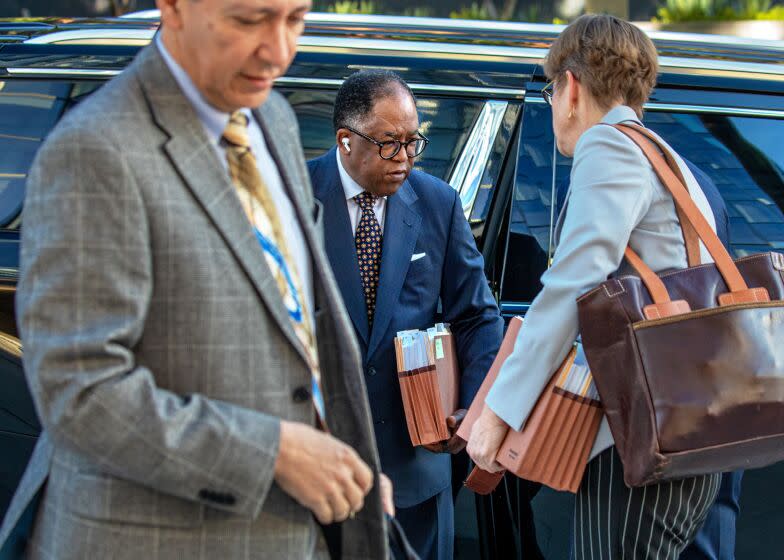 LOS ANGELES, CA - MARCH 09: Suspended Los Angeles City Councilman Mark Ridley-Thomas, center, who while a member of the Board of Supervisors allegedly steered county contracts to USC's social work school in exchange for benefits for his son, facing federal criminal case arrives with his team of attorneys at United States Courthouse on Thursday, March 9, 2023 in Los Angeles, CA. (Irfan Khan / Los Angeles Times)