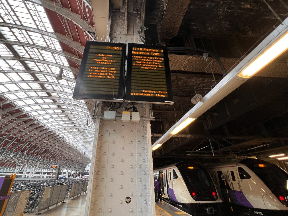 The monitor and Elizabeth line's train at the platform.