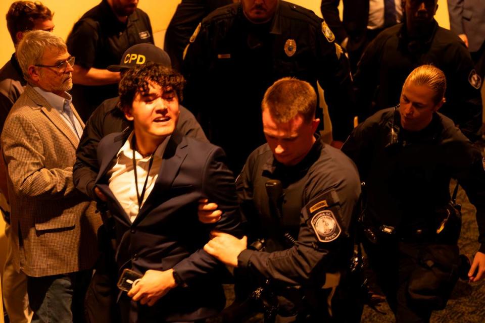 Police escort a person who disrupted President Joe Biden speaking during an appearance at the South Carolina Democratic Party’s First-in-the-Nation Celebration Dinner on Saturday, Jan. 27, 2024.